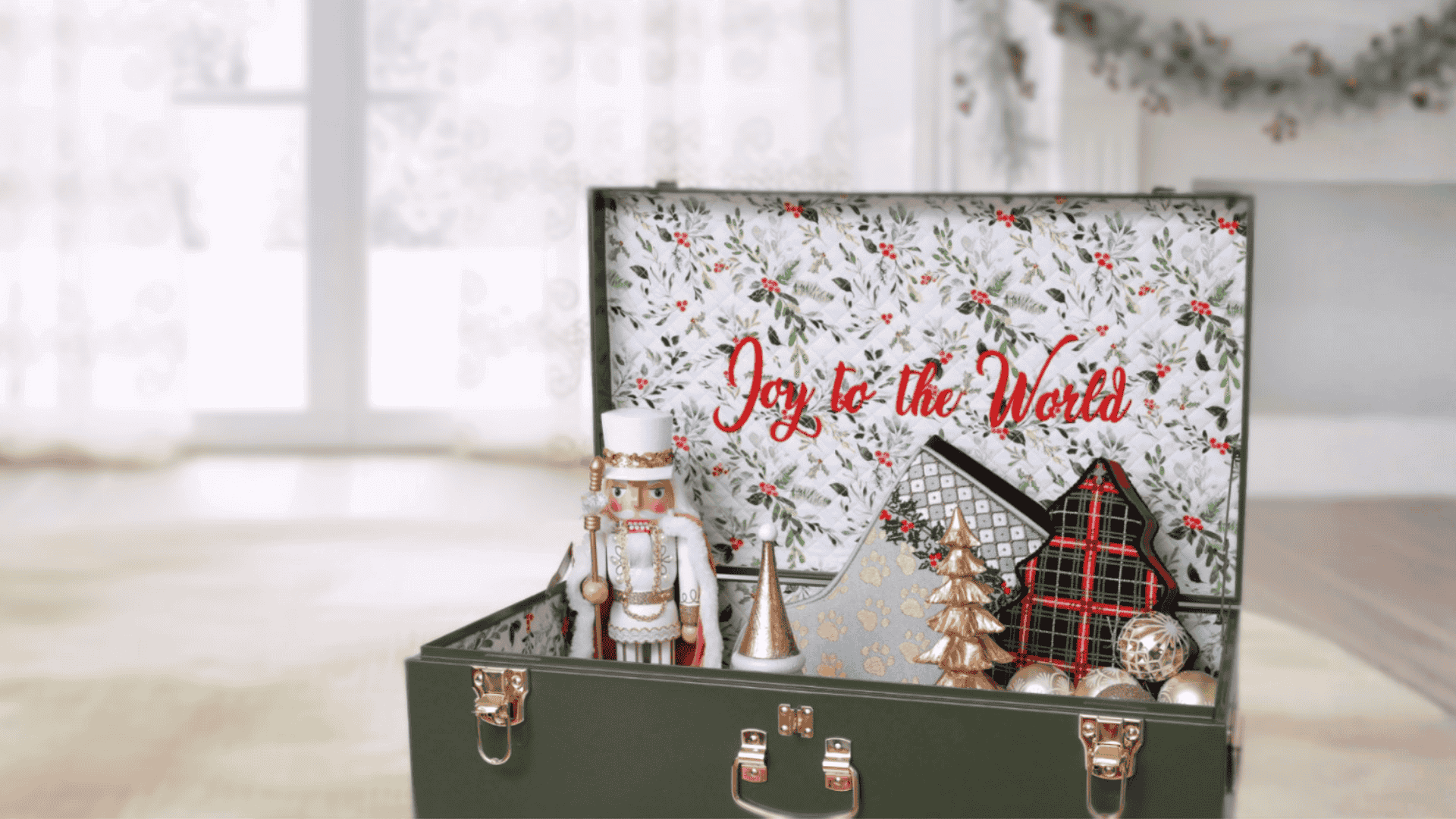 Decorative keepsake trunk with Christmas-themed design and ornaments on a light background