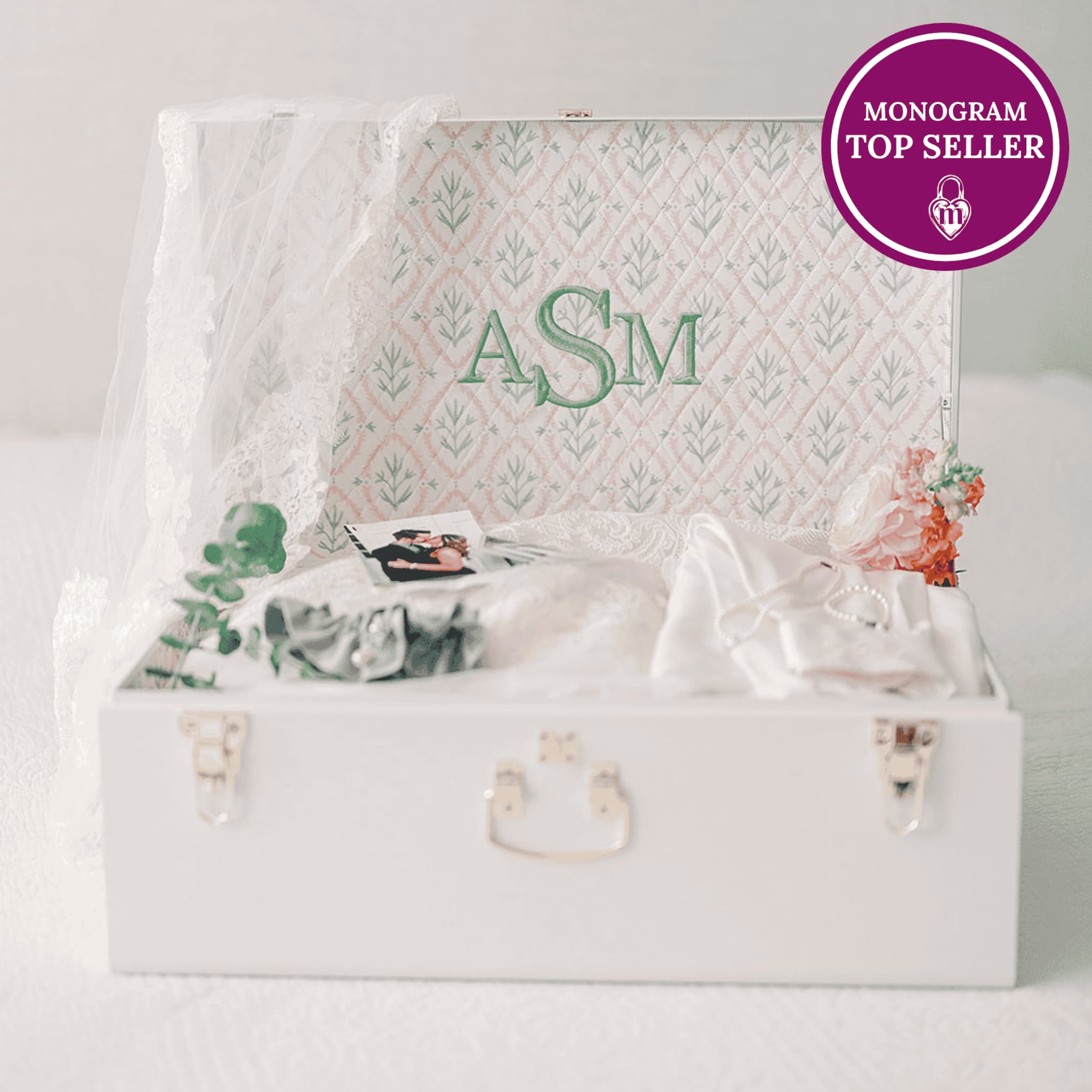White trunk with decorative monogram and floral patterned background