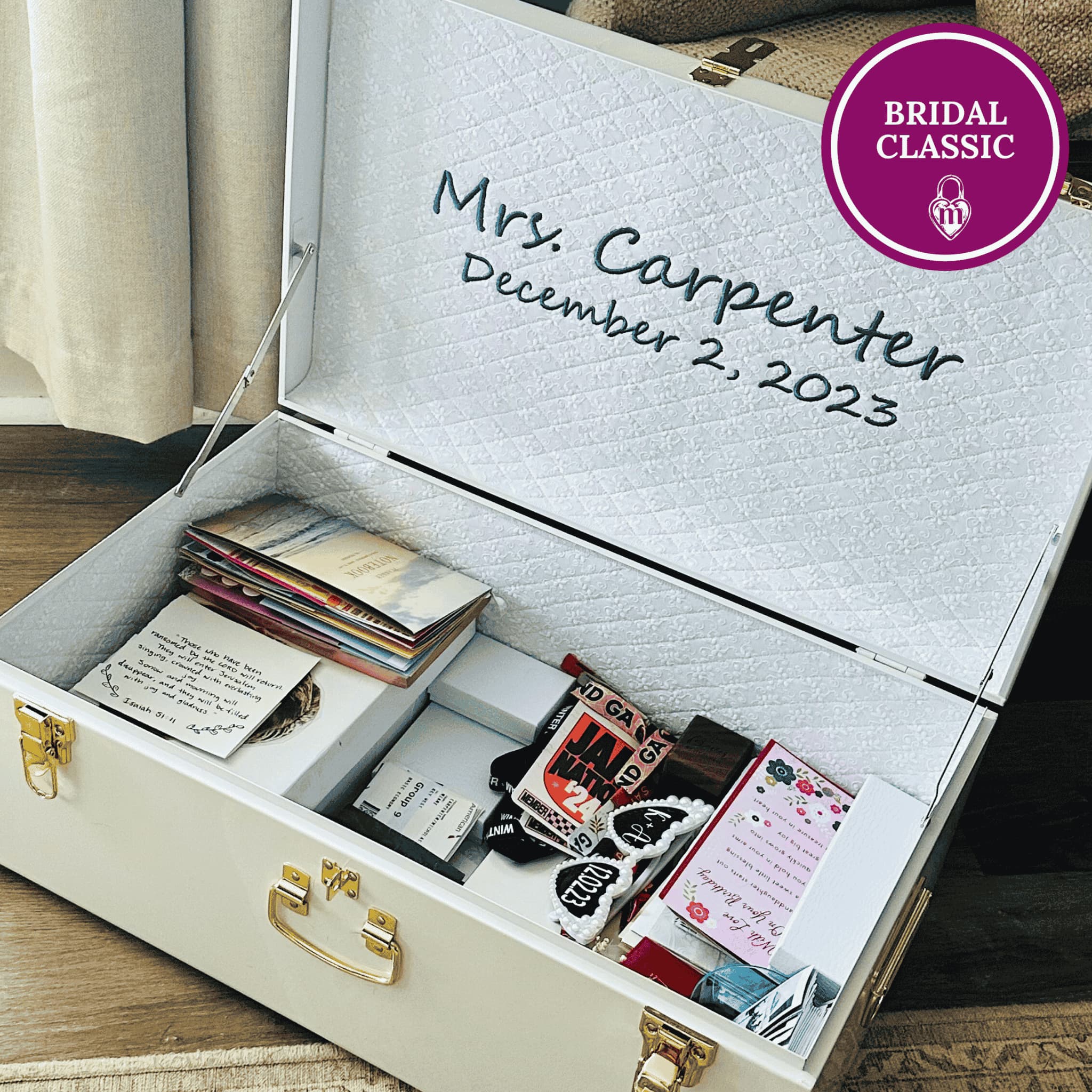 Personalized jewelry box with embroidered name and date, containing wedding cards and memorabilia.