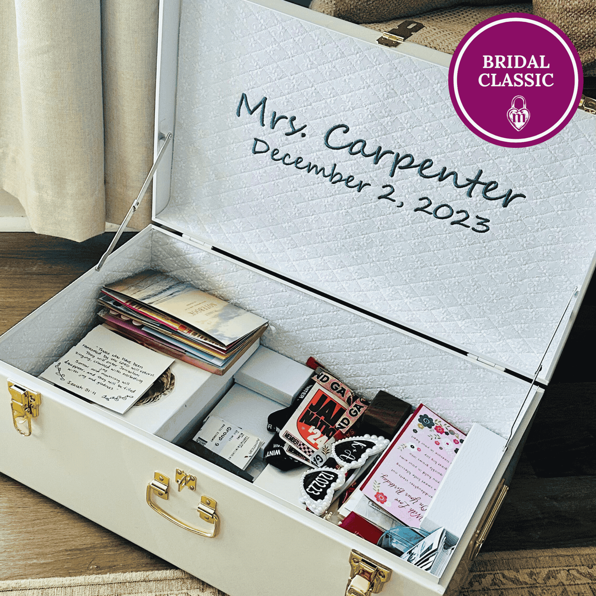 Personalized jewelry box with embroidered name and date, containing wedding cards and memorabilia.