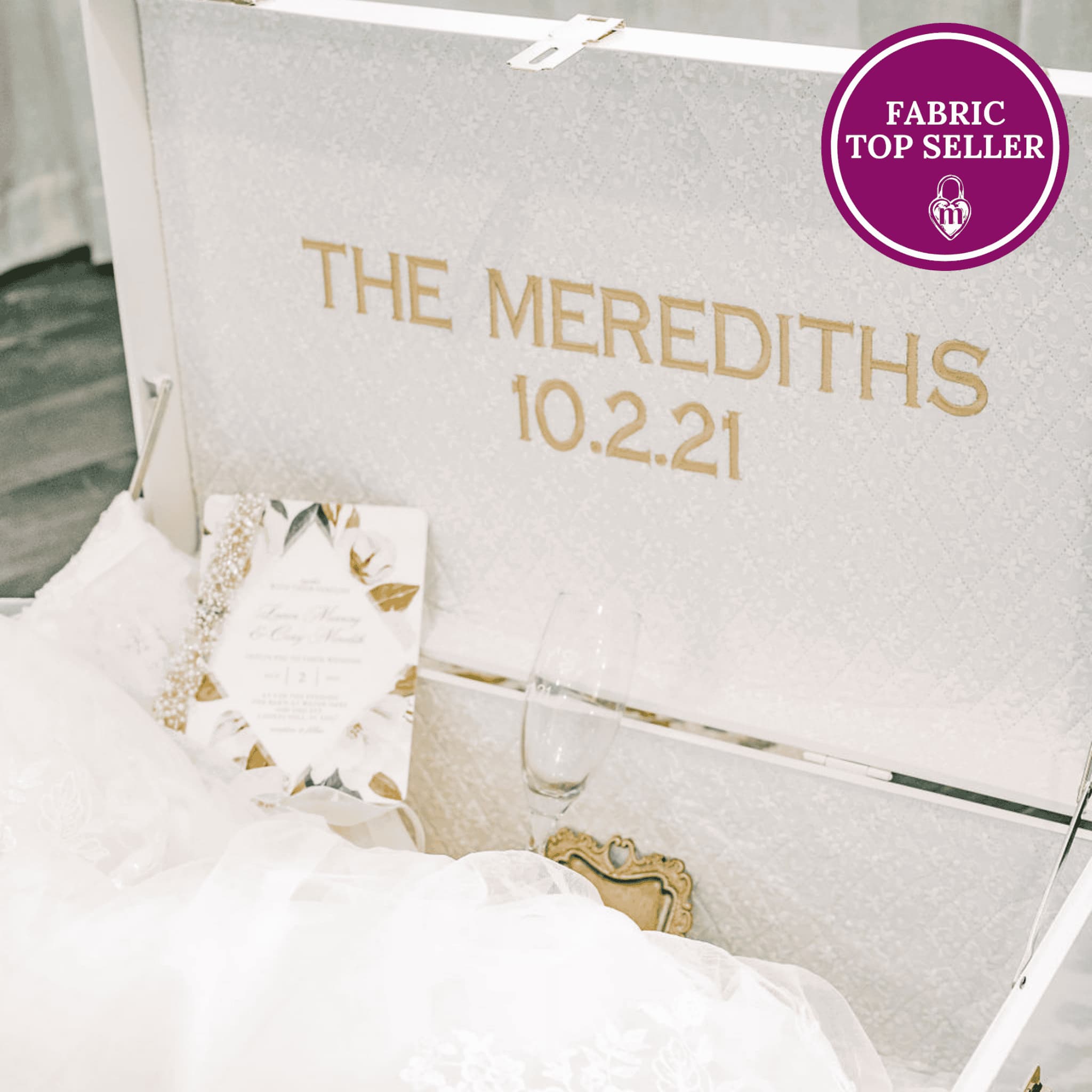 Personalized fabric with 'The Merediths 10.2.21' printed on it, displayed in a decorative setting.
